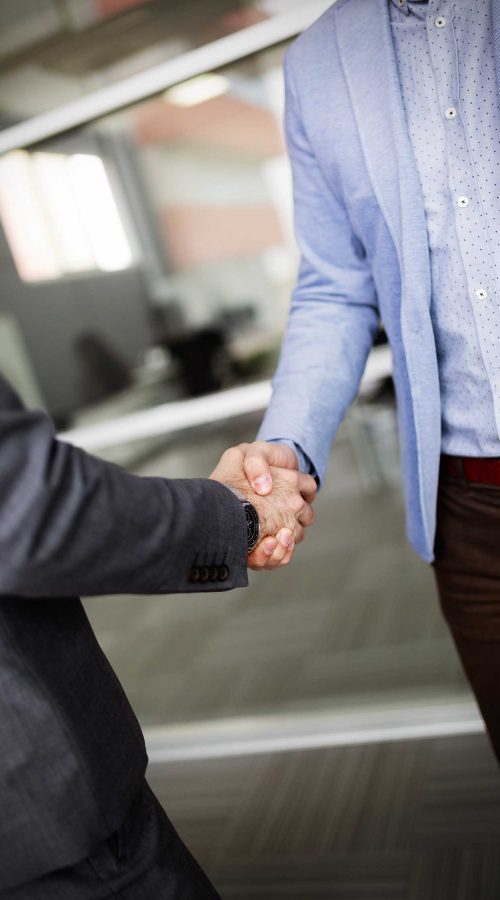 Business people shaking hands, finishing up successful meeting